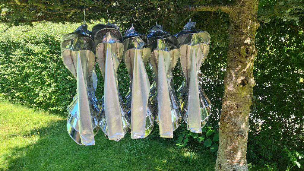 Front view of futuristic silver armor bodysuit photographed outdoors, visionary costume design with geometric structure